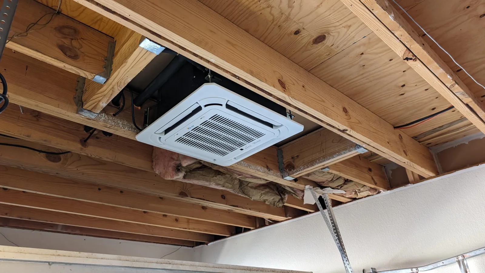 Best DIY concealed duct mini split and ceiling cassette 2026 guide: a recessed ceiling cassette mini split installed flush between floor joists with its four-way airflow grille facing the room