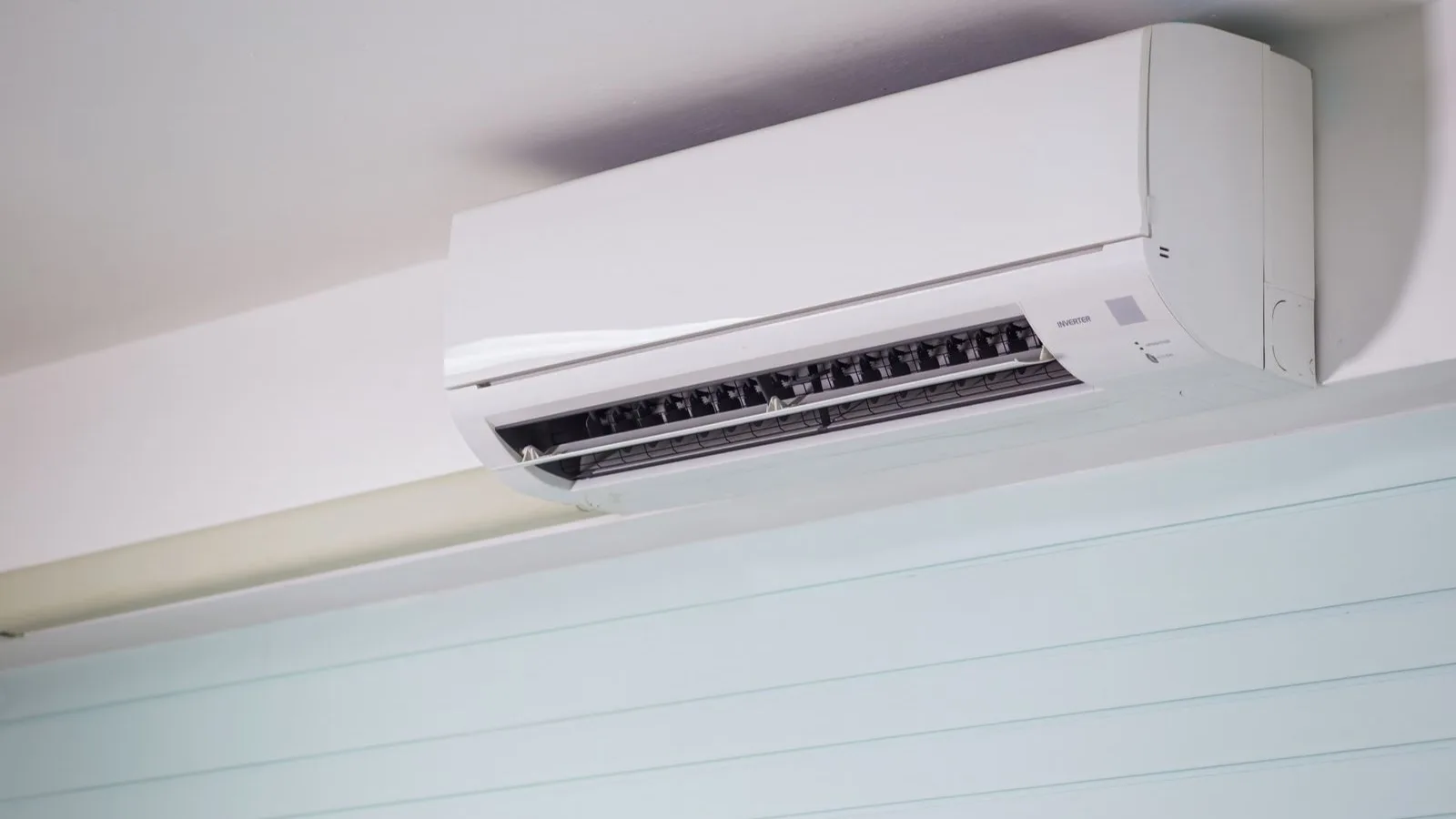 DIY mini split warranty coverage — a wall-mounted inverter mini split indoor head installed near the ceiling, the kind of DIY system covered by MRCOOL DIY 5th Gen and Zone Air parts and compressor warranties